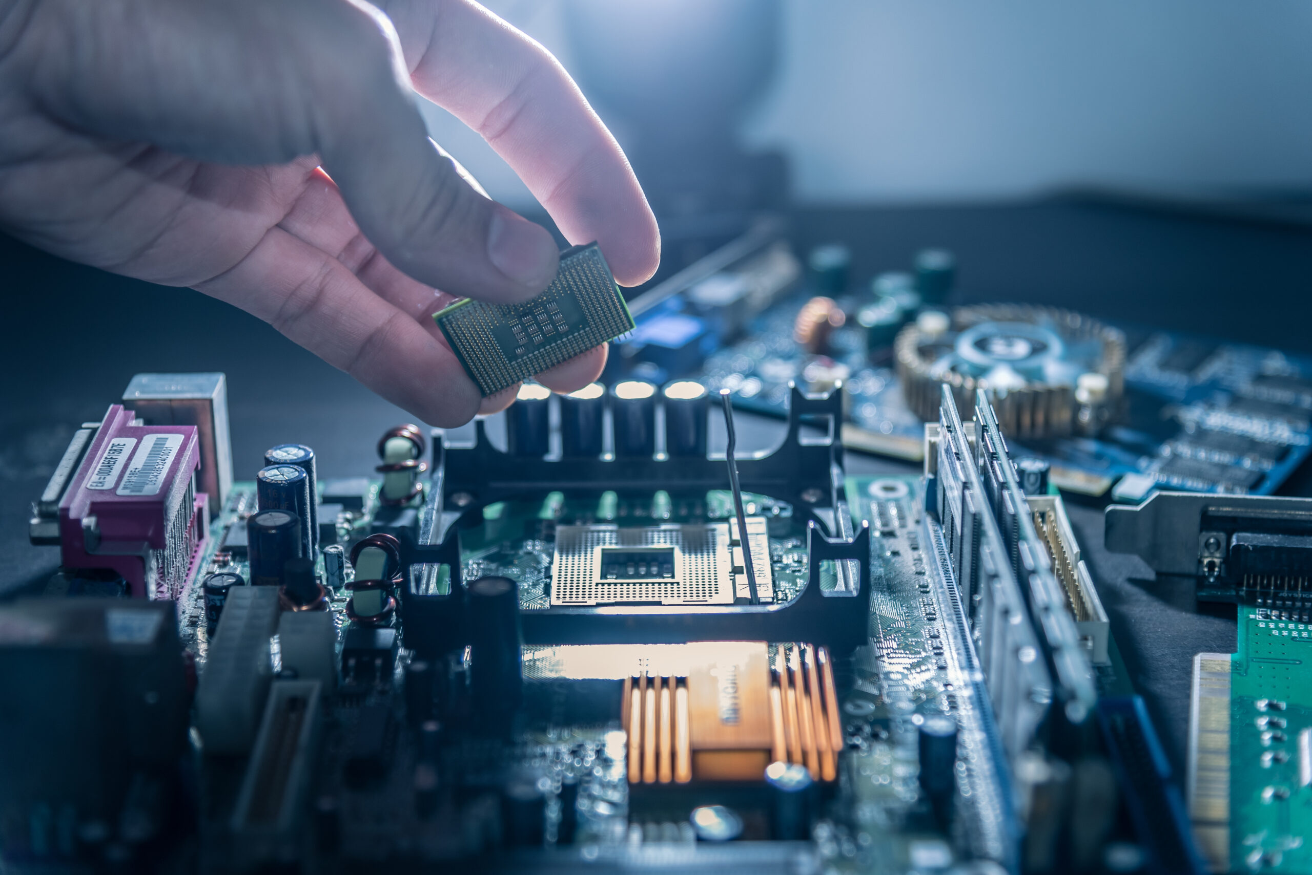 Technician putting CPU into motherboard socket
